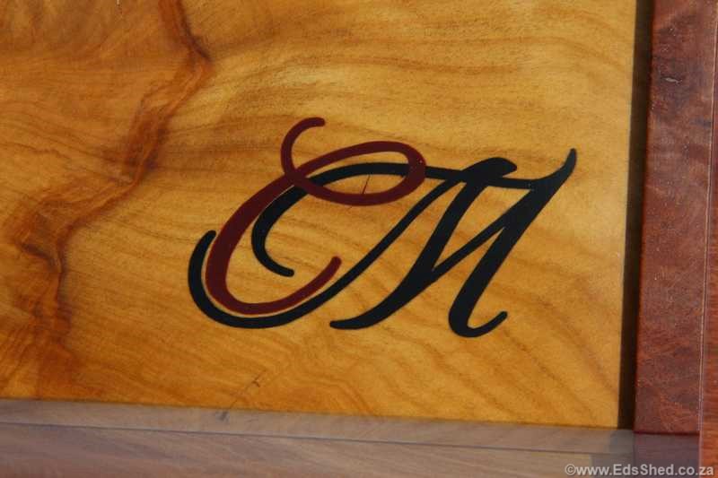 The logo designed by Patrick P was engraved using a pantograph and dremel tool together with some hand carving then filled with epoxy/sawdust. 
