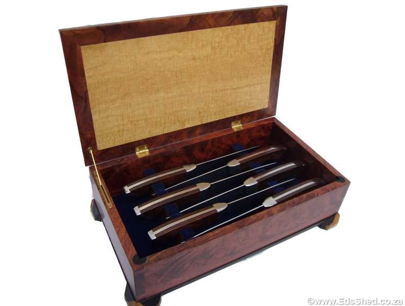 The box contains a set of steak knives. The carcass is from a beautiful specimen of Bubinga with many beautiful deep shadows.